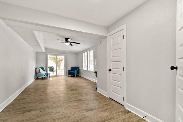 unfurnished room with ceiling fan, lofted ceiling, and wood-type flooring