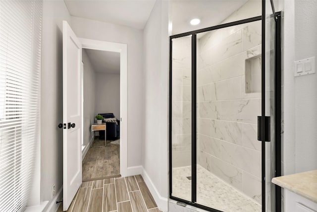 bathroom with a shower with door