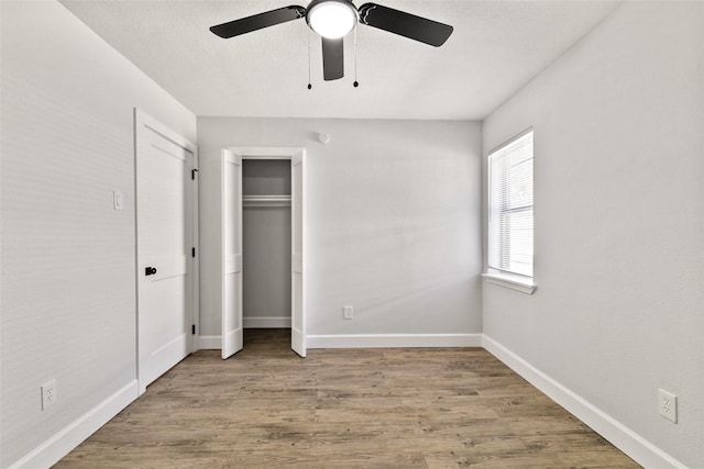 unfurnished bedroom with light hardwood / wood-style floors and ceiling fan