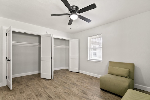 living area featuring light wood-type flooring and ceiling fan