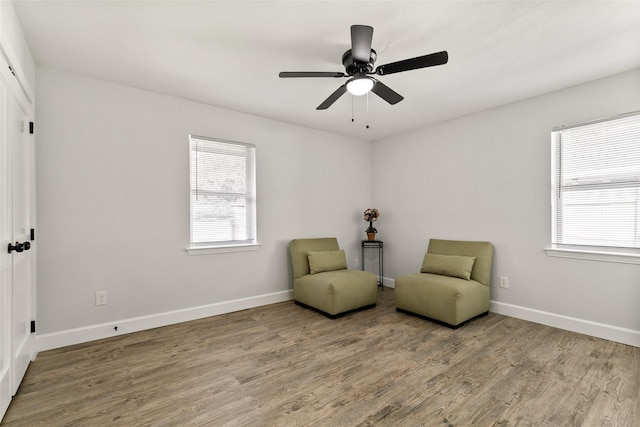 sitting room featuring hardwood / wood-style flooring and ceiling fan