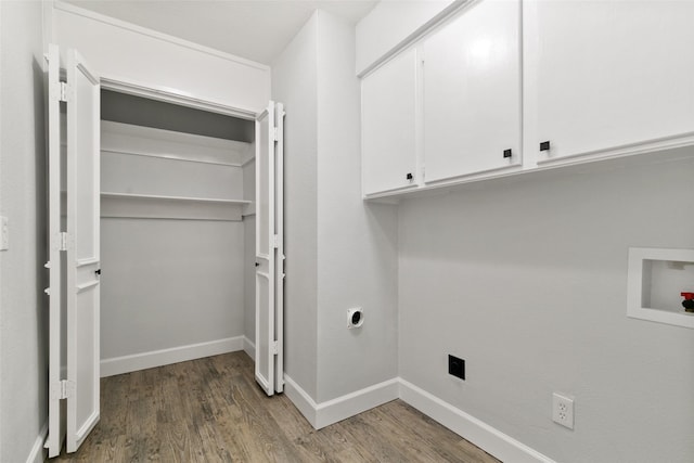 laundry room with hookup for a washing machine, electric dryer hookup, hardwood / wood-style floors, and cabinets