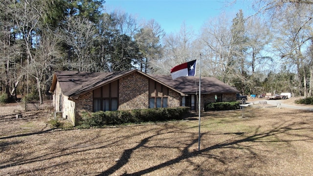 view of side of home featuring a lawn