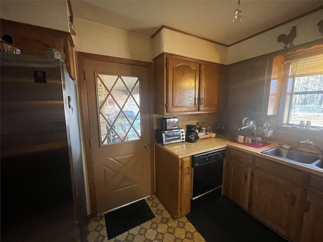 kitchen featuring sink, dishwasher, and stainless steel refrigerator