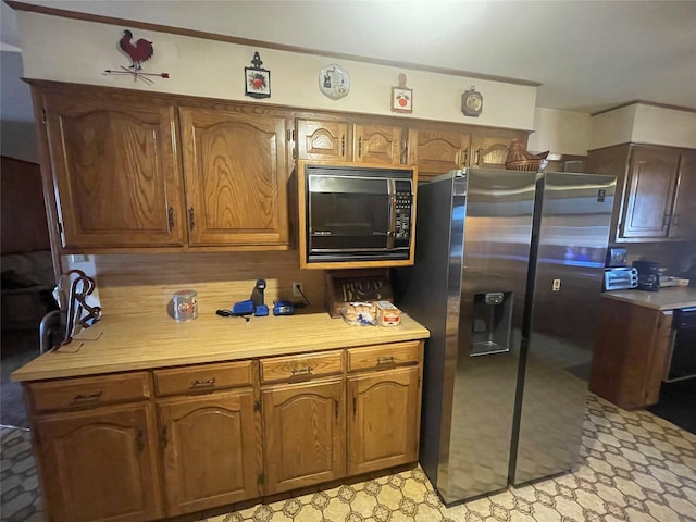 kitchen with black microwave and stainless steel fridge with ice dispenser