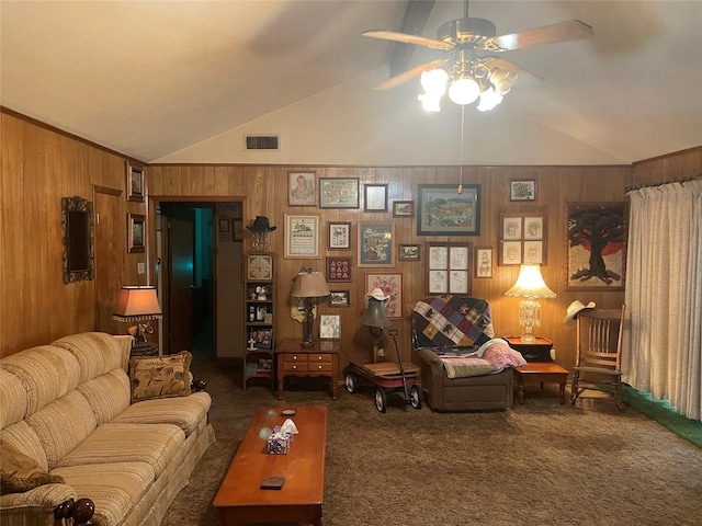 carpeted living room featuring ceiling fan, wood walls, and lofted ceiling