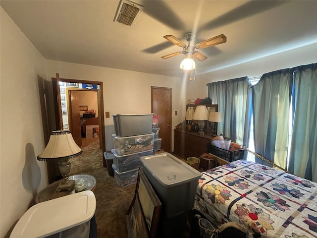 bedroom featuring dark carpet and ceiling fan