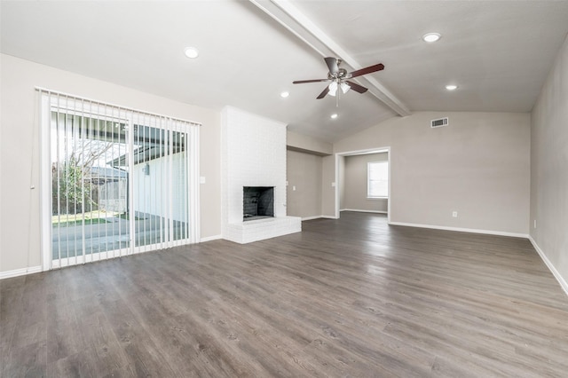 unfurnished living room with ceiling fan, dark hardwood / wood-style flooring, lofted ceiling with beams, and a fireplace