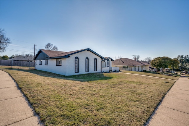 ranch-style home featuring a front yard