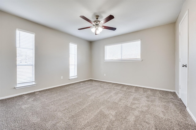 carpeted spare room with ceiling fan