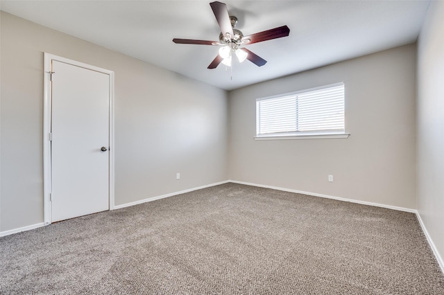 carpeted spare room with ceiling fan