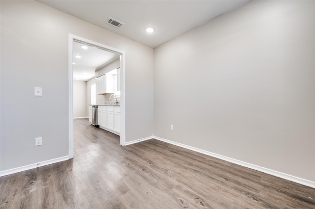 empty room with sink and hardwood / wood-style floors