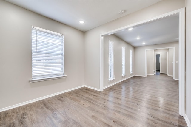 unfurnished room with light wood-type flooring