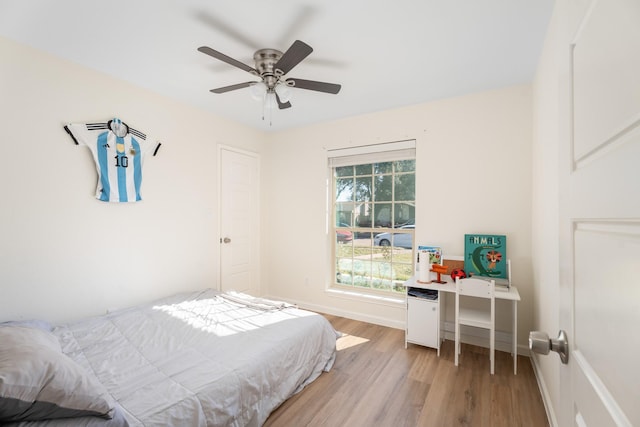 bedroom featuring multiple windows, light wood-type flooring, and ceiling fan