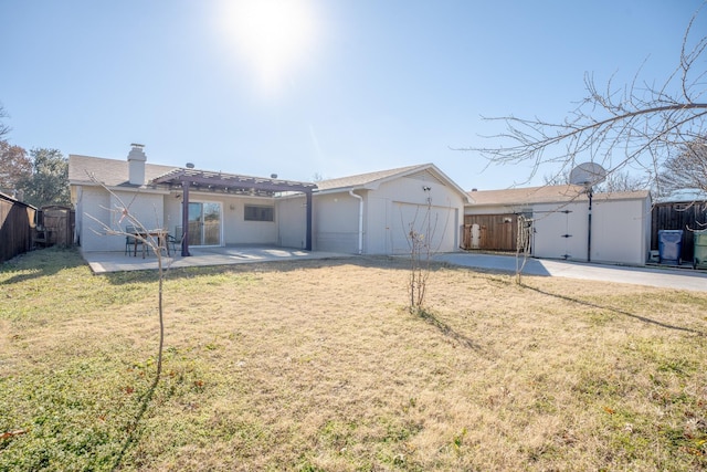 view of front of house with a garage, a pergola, a patio area, and a front lawn