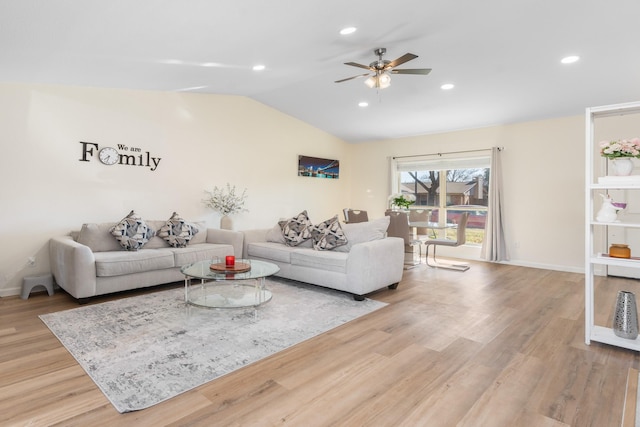 living room featuring vaulted ceiling, ceiling fan, and light hardwood / wood-style floors