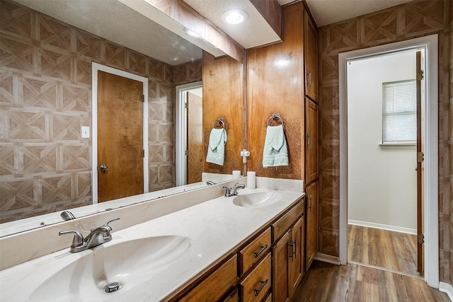 bathroom featuring hardwood / wood-style flooring, a textured ceiling, and vanity