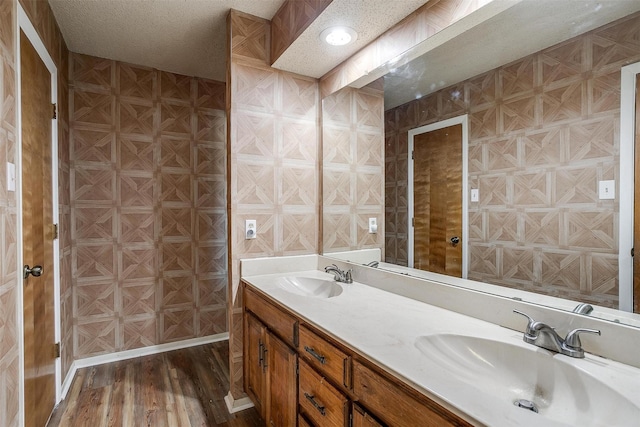 bathroom with vanity, hardwood / wood-style floors, and a textured ceiling