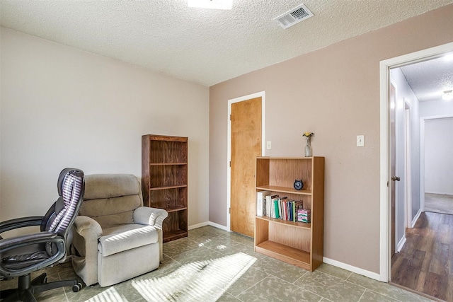 sitting room with a textured ceiling