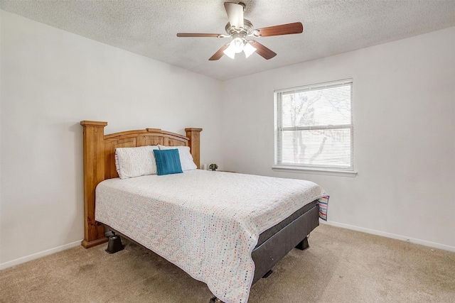 carpeted bedroom featuring a textured ceiling and ceiling fan