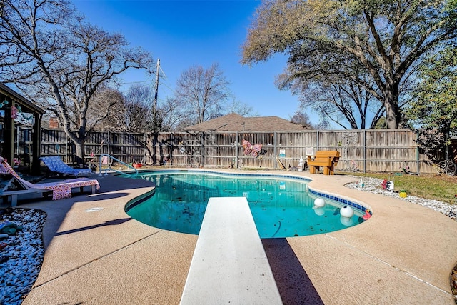 view of pool featuring a patio area and a diving board