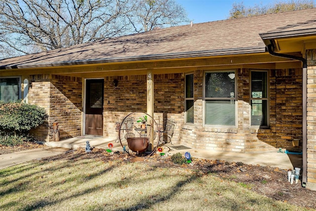 property entrance with a lawn