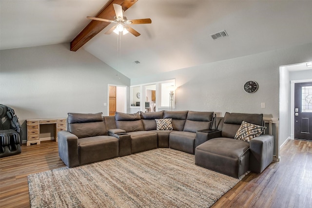 living room featuring ceiling fan, hardwood / wood-style floors, high vaulted ceiling, and beam ceiling