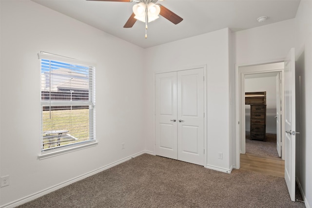 unfurnished bedroom featuring carpet floors, a closet, and ceiling fan