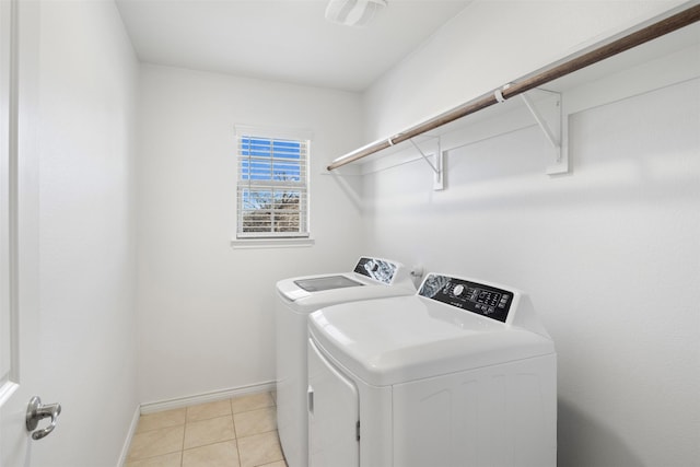 laundry area featuring washer and clothes dryer and light tile patterned flooring