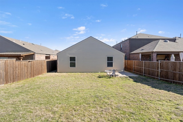 rear view of property with a lawn