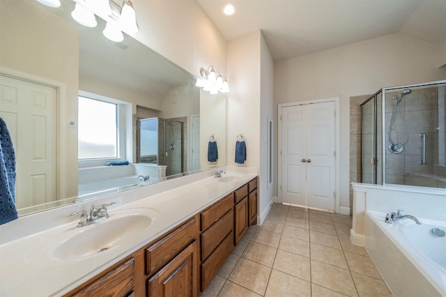 bathroom with tile patterned flooring, vanity, lofted ceiling, and independent shower and bath