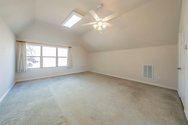 additional living space featuring vaulted ceiling, light colored carpet, and ceiling fan