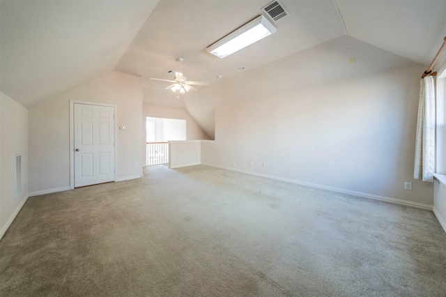 additional living space featuring vaulted ceiling, carpet flooring, and ceiling fan