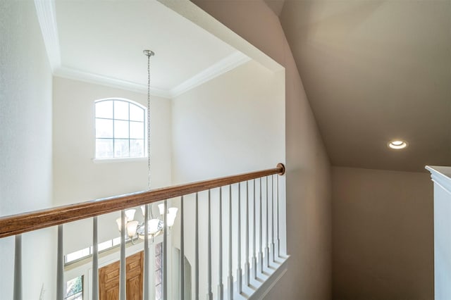 corridor featuring crown molding and a chandelier