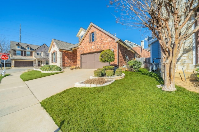 view of front property featuring a garage and a front yard