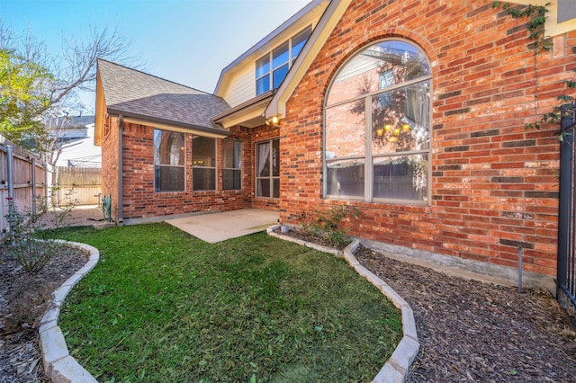 back of property with a patio and a lawn