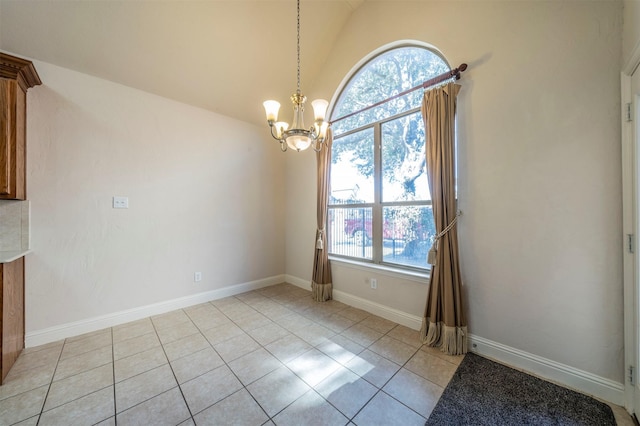 unfurnished dining area with a notable chandelier, lofted ceiling, light tile patterned floors, and plenty of natural light