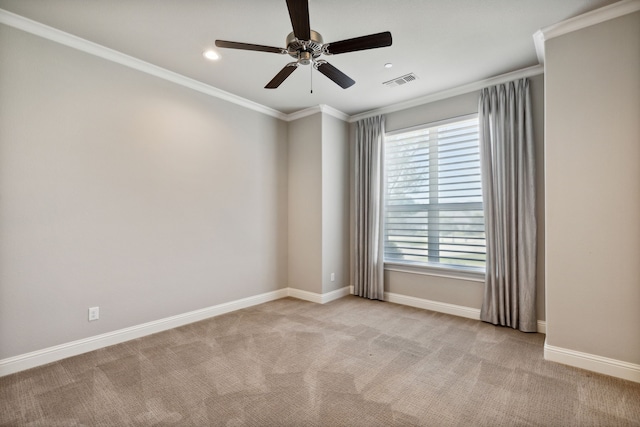 spare room featuring ceiling fan, ornamental molding, and light carpet