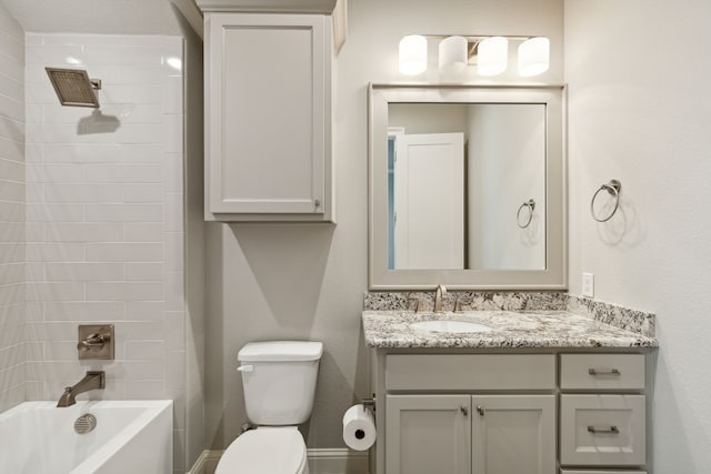 full bathroom featuring vanity, toilet, and tiled shower / bath combo