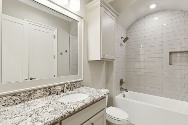 full bathroom featuring vanity, toilet, and tiled shower / bath