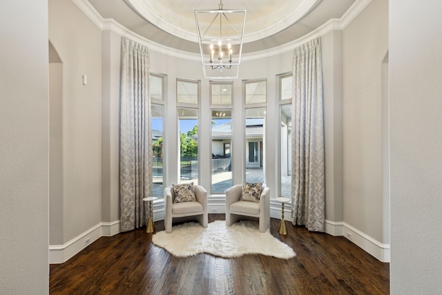 sitting room with crown molding, dark hardwood / wood-style floors, a notable chandelier, and a raised ceiling