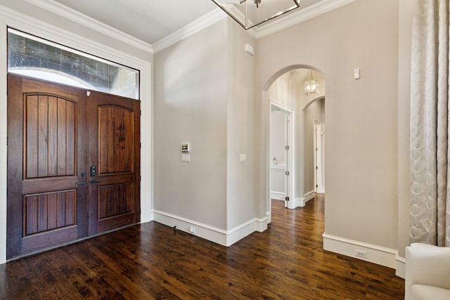 foyer entrance with dark wood-type flooring and ornamental molding