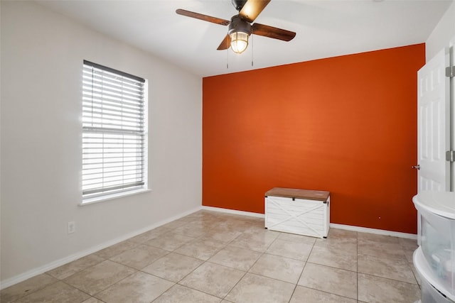 unfurnished room with ceiling fan and light tile patterned floors