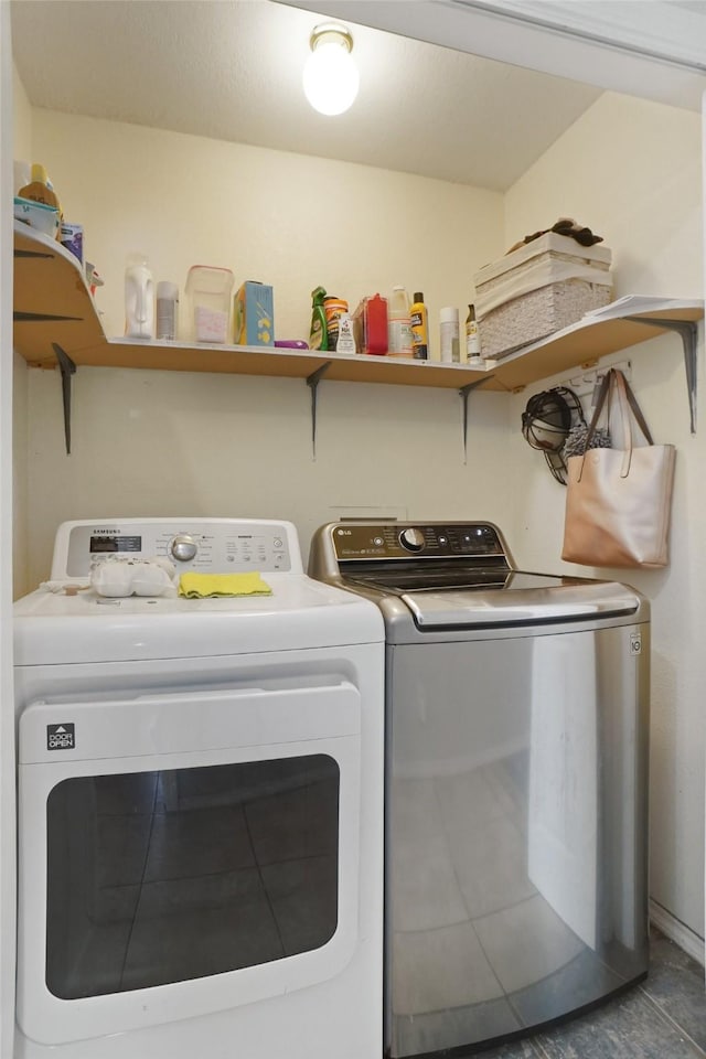 clothes washing area featuring separate washer and dryer