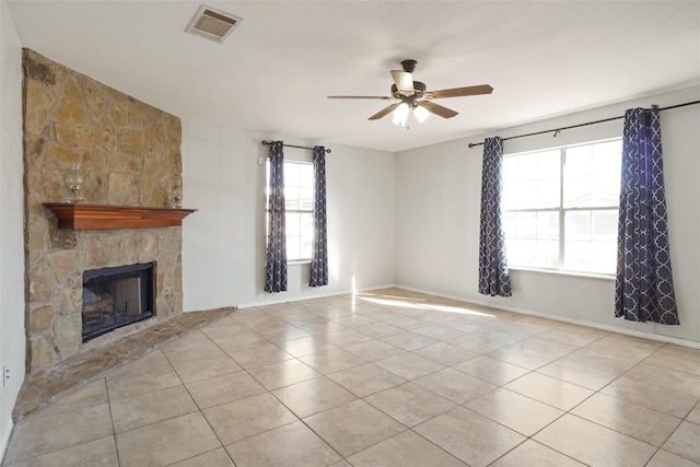 unfurnished living room with ceiling fan, light tile patterned floors, and a fireplace