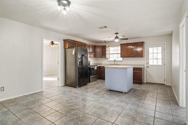 kitchen featuring a center island, black refrigerator with ice dispenser, ceiling fan, and electric stove