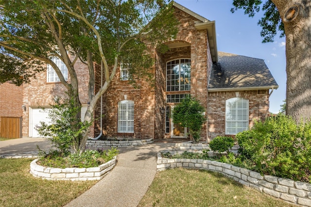 view of front facade with a garage and a front yard