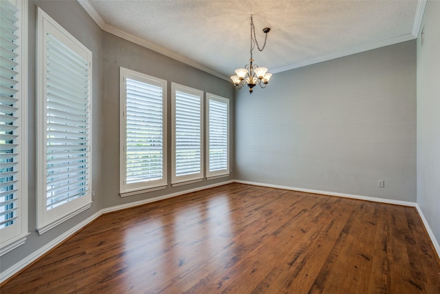 empty room with a notable chandelier, crown molding, and dark hardwood / wood-style floors