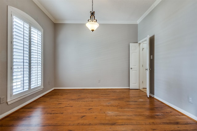 unfurnished room with plenty of natural light, hardwood / wood-style floors, and crown molding