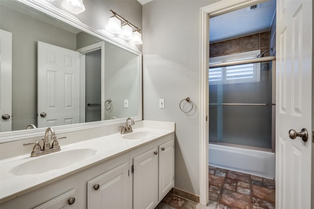 bathroom with shower / bath combination with glass door and vanity